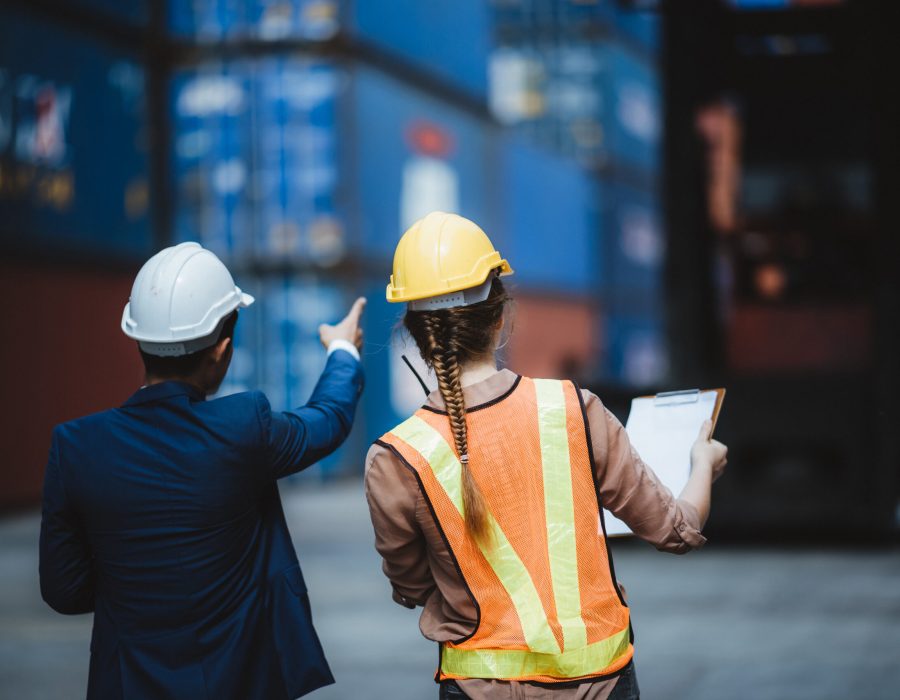 executives businessmen, and engineers or foreman wear medical face masks. Quality Control Officer inspecting warehouses at containers yard for international shipping businesses Concepts of import and export